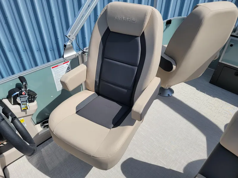 Slide: The Image of 2025 Harris Cruiser 230 boat captain's chair with beige and black upholstery. - 10