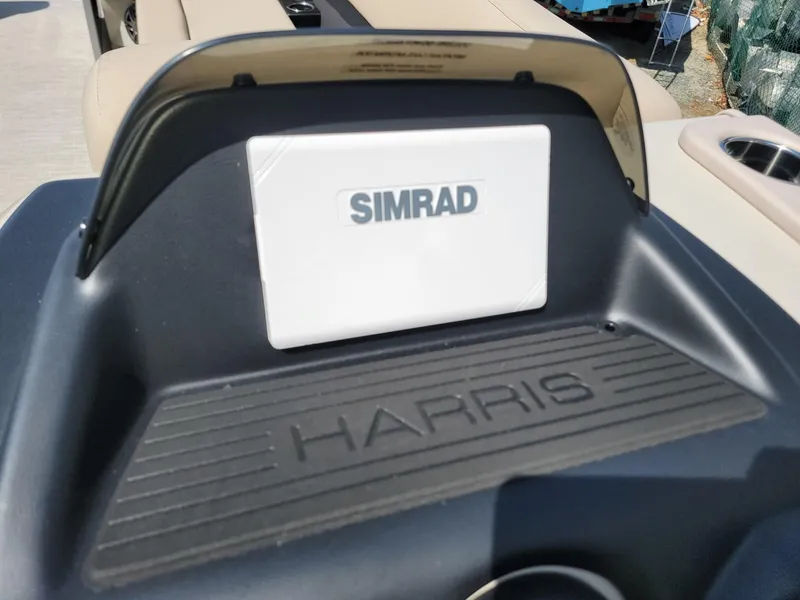 Slide: The Image of 2025 Harris Cruiser 230 boat dashboard with Simrad navigation system. - 12