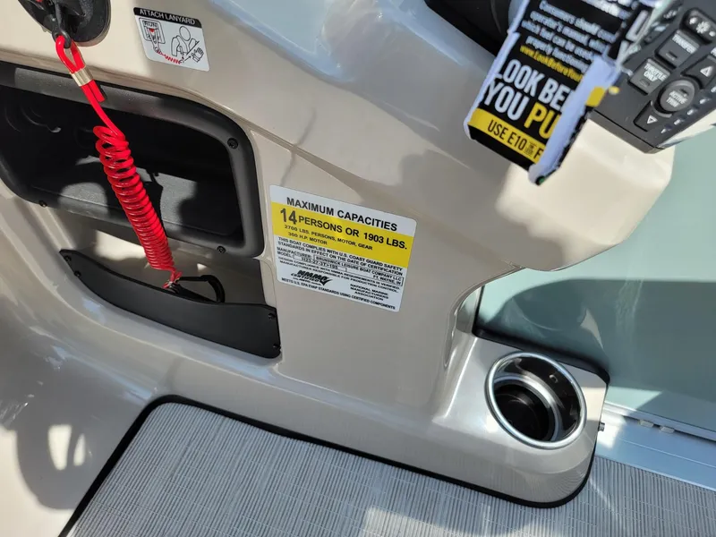 Slide: The Image of 2025 Harris Cruiser 230 boat interior showing maximum capacity label and safety features. - 15