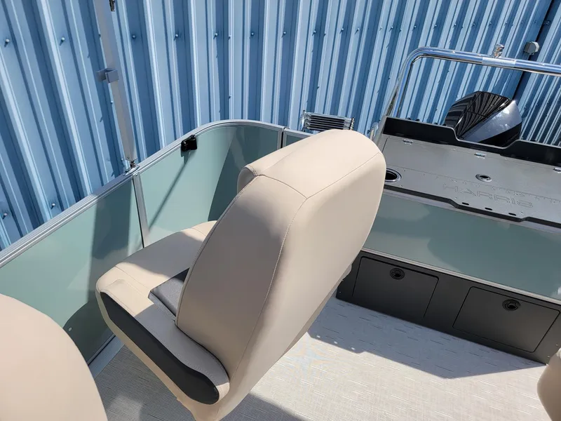 Slide: The Image of 2025 Harris Cruiser 230 boat interior with beige seating and storage compartments. - 16