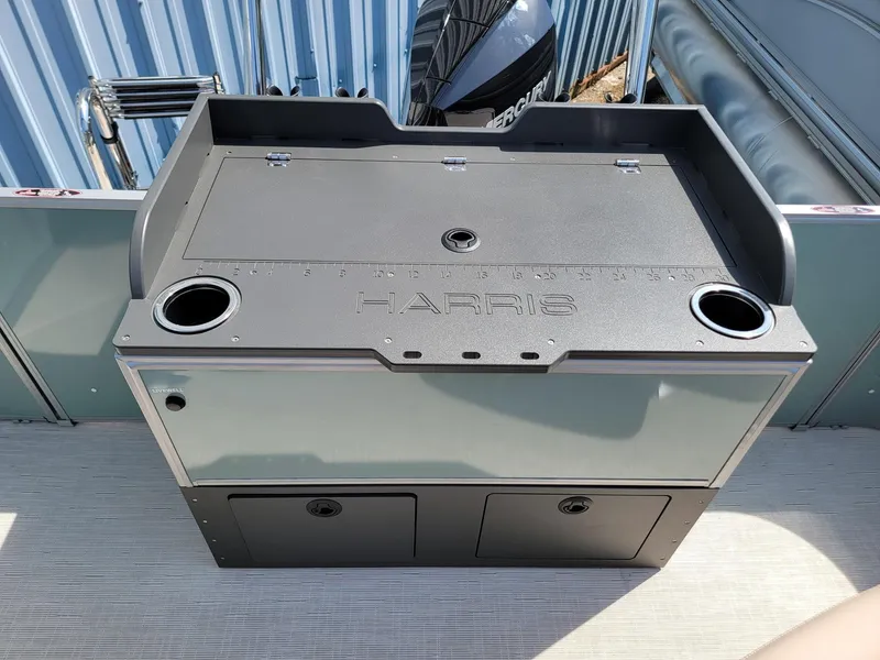 Slide: The Image of 2025 Harris Cruiser 230 boat console with storage and cup holders. - 18