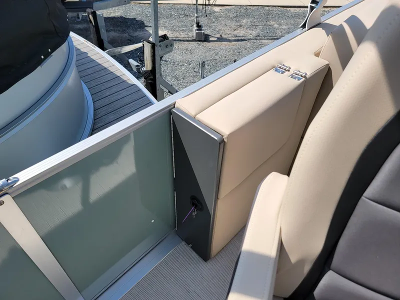 Slide: The Image of 2025 Harris Cruiser 230 boat interior with beige seating and storage compartment. - 21