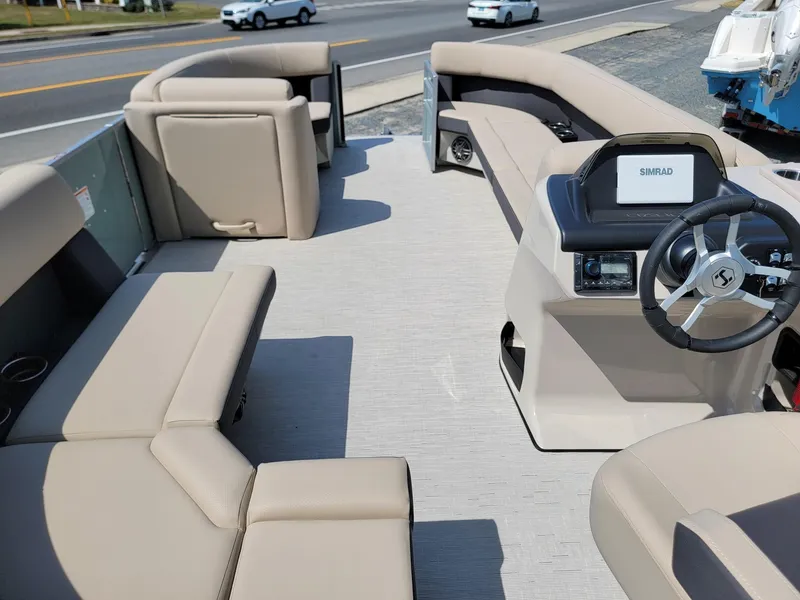 Slide: The Image of 2025 Harris Cruiser 230 pontoon boat with beige seating and modern helm. - 25