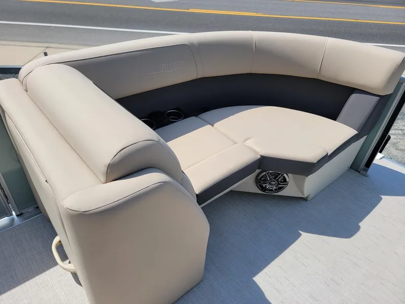 Slide: The Image of 2025 Harris Cruiser 230 boat with beige seating and built-in speakers. - 30