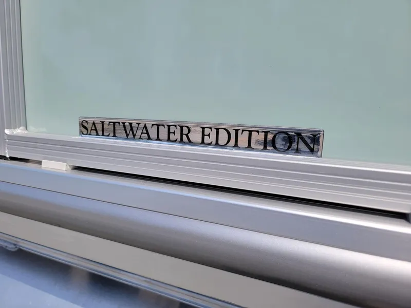 Slide: The Image of 2025 Harris Cruiser 230 Saltwater Edition badge on boat exterior. - 32