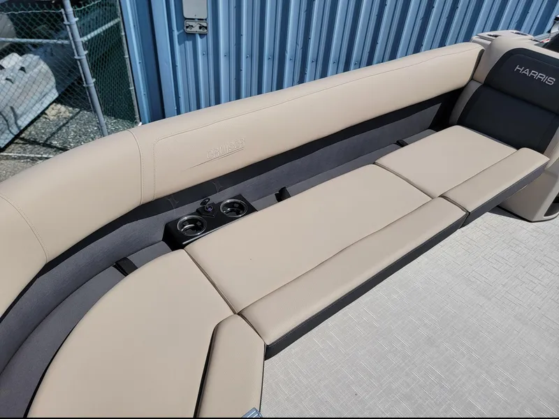 Slide: The Image of 2025 Harris Cruiser 230 boat interior with beige seating and cup holders. - 7