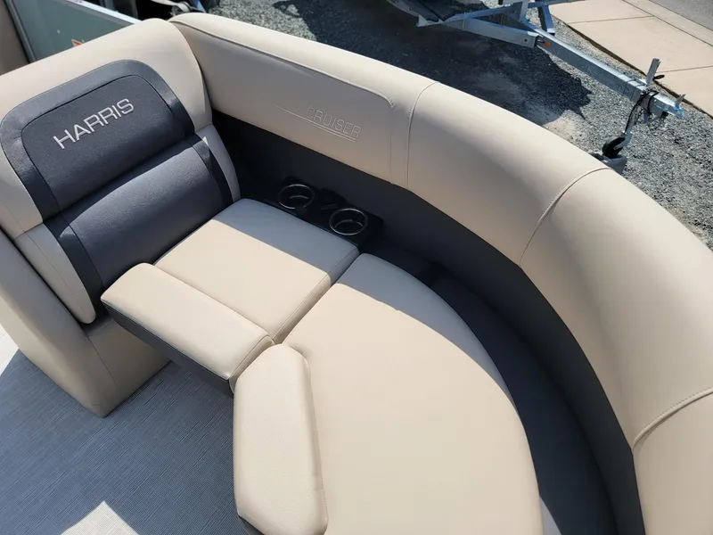Slide: The Image of 2025 Harris Cruiser 230 boat interior with beige seating and cup holders. - 8