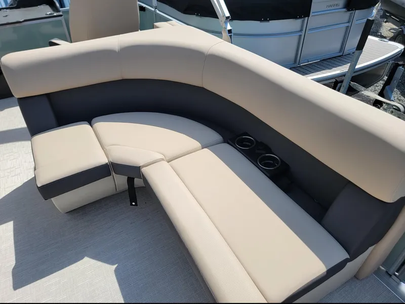 Slide: The Image of 2025 Harris Cruiser 230 boat seating with beige and gray upholstery. - 9