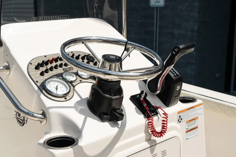 Slide: The Image of 2024 Carolina Skiff 17 LS boat console with steering wheel and controls. - 10