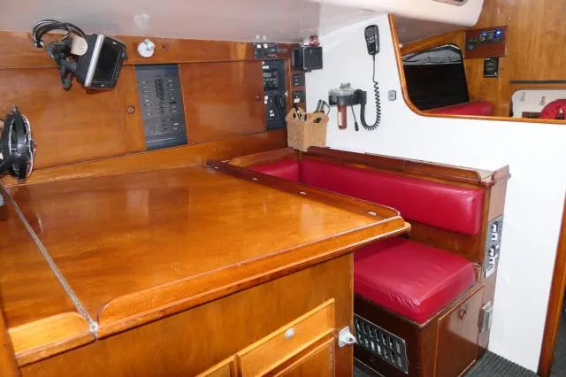 Slide: The Image of Interior of 1970 Southern Ocean GALLANT 53 sailboat with wooden cabinetry and red seating. - 10