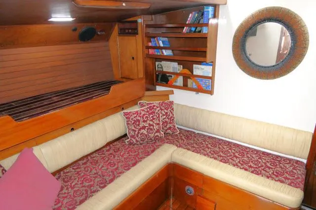 Slide: The Image of Cozy interior of 1970 Southern Ocean GALLANT 53 sailboat with cushioned seating and bookshelf. - 18
