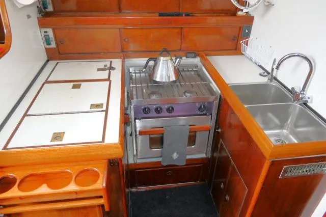 Slide: The Image of Vintage 1970 Southern Ocean GALLANT 53 yacht kitchen with stove, sink, and wooden cabinetry. - 6