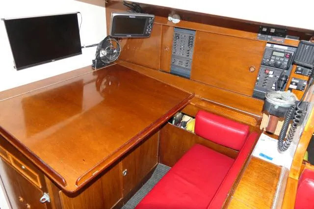 Slide: The Image of Navigation station of 1970 Southern Ocean GALLANT 53 yacht with wooden desk and red seating. - 9