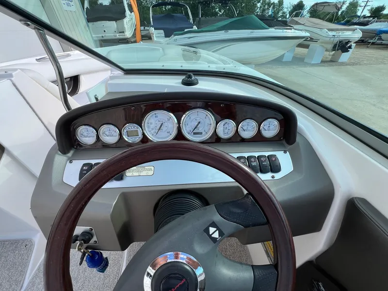 Slide: The Image of 2006 Regal 2200 Bowrider dashboard with gauges and steering wheel. - 13