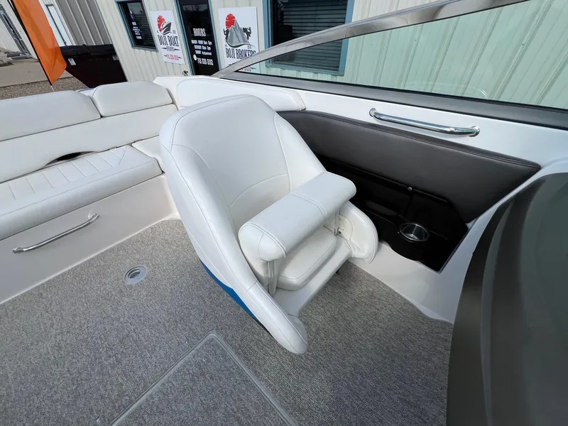 Slide: The Image of Interior of a 2006 Regal 2200 Bowrider boat with white seating and carpeted floor. - 17