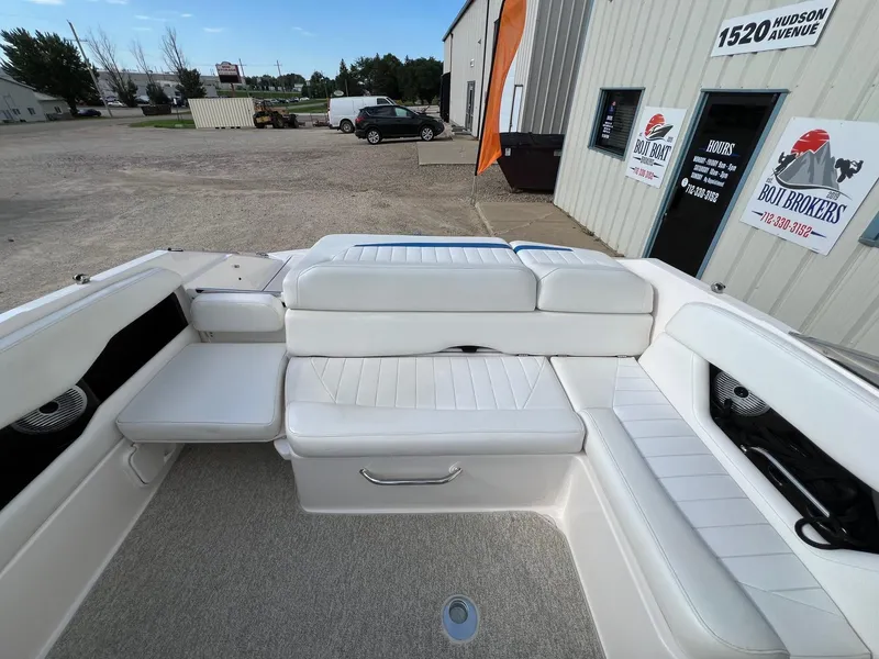 Slide: The Image of 2006 Regal 2200 Bowrider boat interior with white seating at dealership. - 18