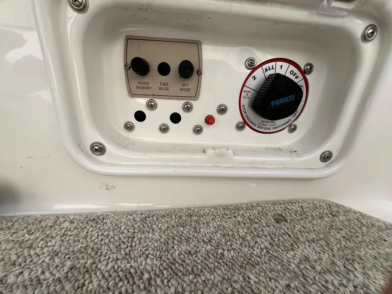Slide: The Image of 2006 Regal 2200 Bowrider control panel with bilge switches and Perko battery selector. - 20