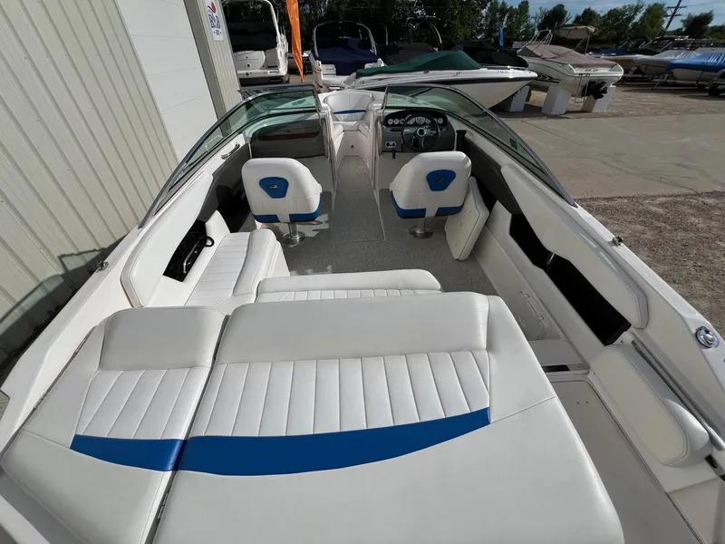 Slide: The Image of 2006 Regal 2200 Bowrider interior with white and blue seating, dashboard, and open layout. - 26