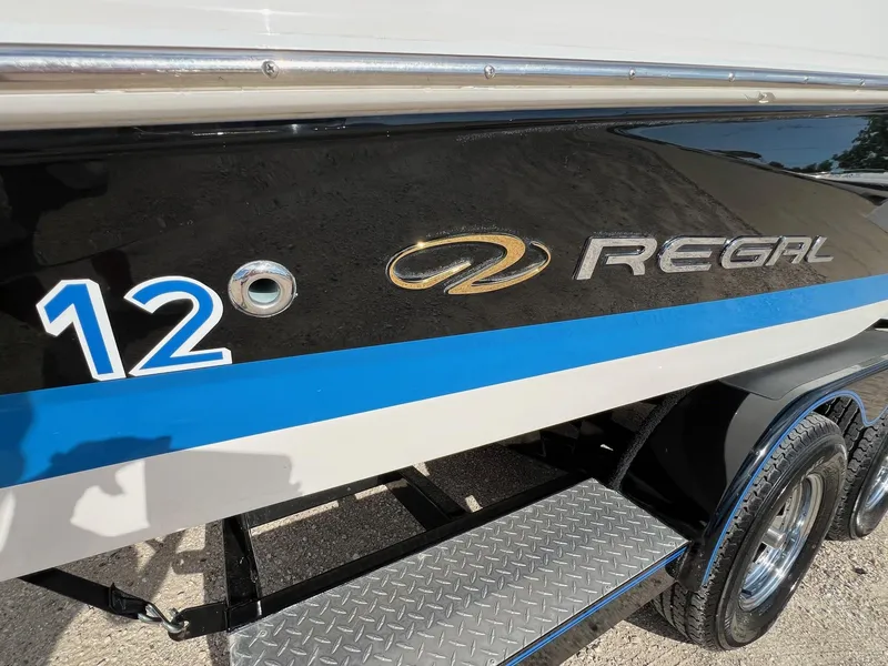 Slide: The Image of 2006 Regal 2200 Bowrider boat side view with logo and number 12. - 29