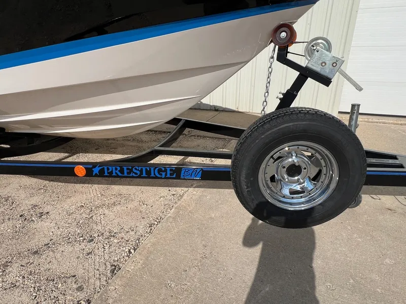 Slide: The Image of 2006 Regal 2200 Bowrider on Prestige trailer, close-up of boat hull and trailer wheel. - 31