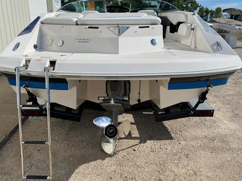 Slide: The Image of 2006 Regal 2200 Bowrider boat rear view with ladder and propeller. - 4