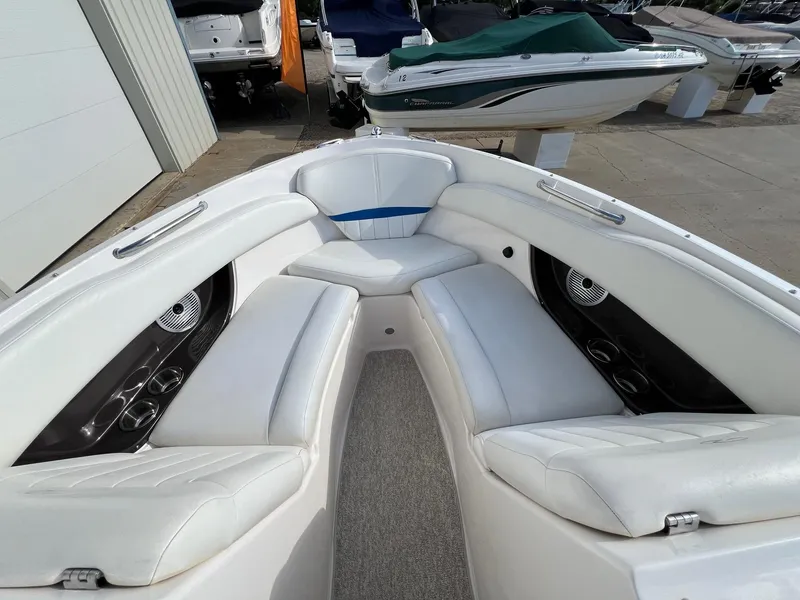 Slide: The Image of 2006 Regal 2200 Bowrider boat interior with white seating and cup holders. - 6