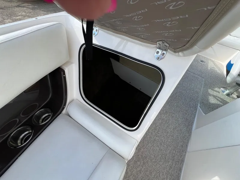 Slide: The Image of Open storage compartment in a 2006 Regal 2200 Bowrider boat. - 8