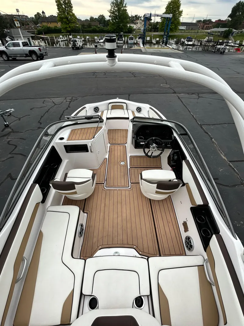 Slide: The Image of 2022 Yamaha Boats 195 S interior with teak flooring and white seating. - 4