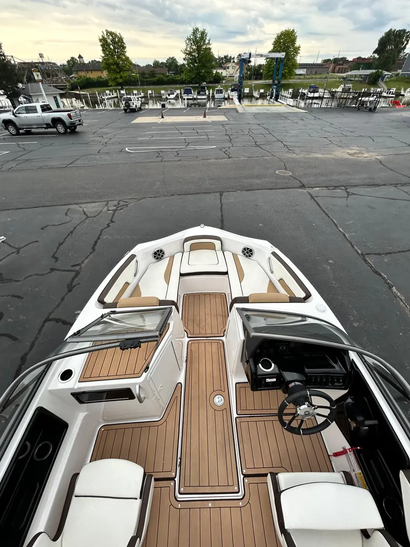 Slide: The Image of 2022 Yamaha Boats 195 S with luxurious interior and spacious deck. - 5