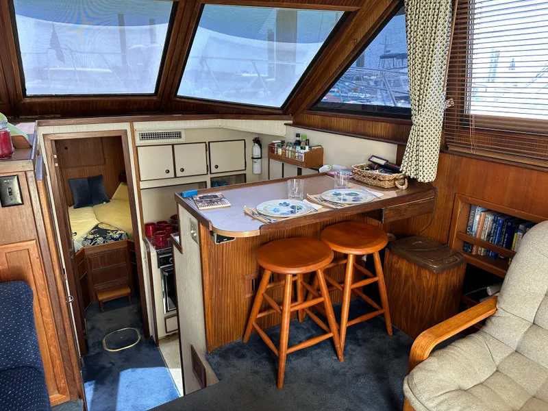 Slide: The Image of Interior of 1985 Hatteras 36 Convertible yacht with cozy dining area and cabin. - 11
