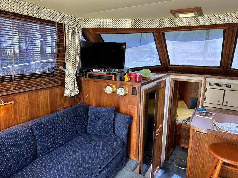 Slide: The Image of Interior of 1985 Hatteras 36 Convertible yacht with blue sofa and TV. - 12