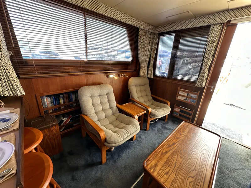 Slide: The Image of Interior of 1985 Hatteras 36 Convertible yacht with cozy seating and wooden accents. - 13