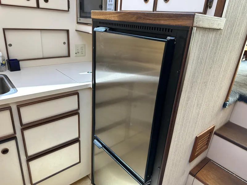 Slide: The Image of 1985 Hatteras 36 Convertible kitchen with stainless steel refrigerator. - 20