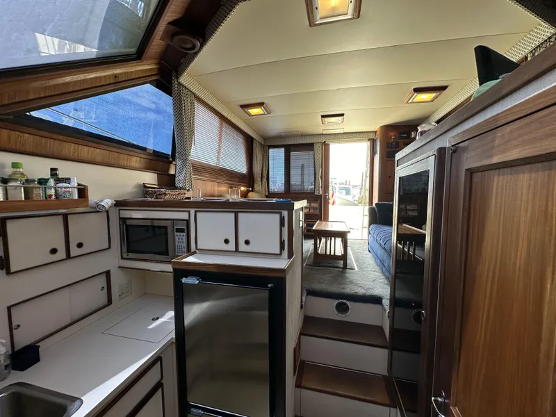 Slide: The Image of Interior of 1985 Hatteras 36 Convertible yacht with kitchen and seating area. - 22