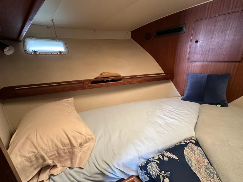 Slide: The Image of Cozy cabin interior of 1985 Hatteras 36 Convertible yacht with bed and pillows. - 24