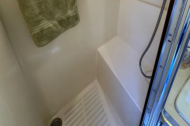 Slide: The Image of 1985 Hatteras 36 Convertible shower area with towel and handheld showerhead. - 30