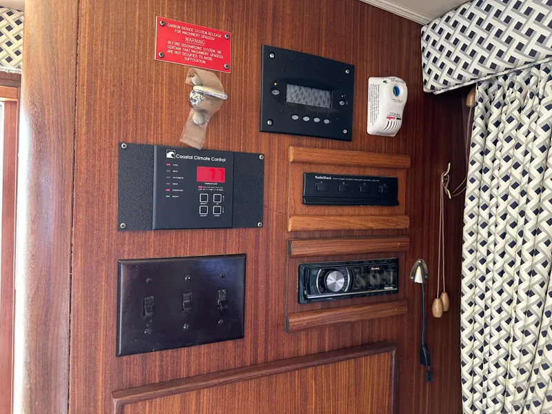 Slide: The Image of Control panel of a 1985 Hatteras 36 Convertible boat with various switches and gauges. - 34