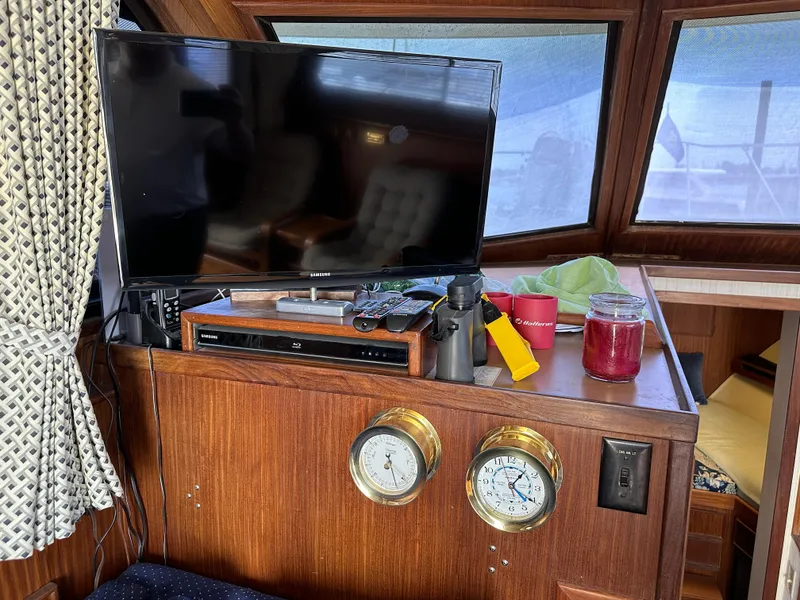 Slide: The Image of Interior of 1985 Hatteras 36 Convertible with TV, gauges, and nautical decor. - 35