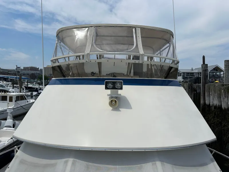 Slide: The Image of 1985 Hatteras 36 Convertible boat docked at a marina. - 38