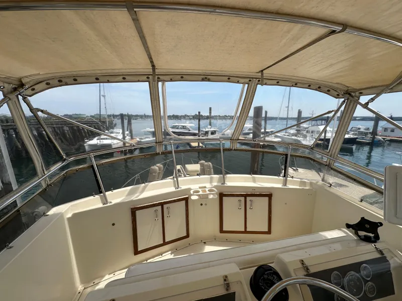 Slide: The Image of Cockpit view of 1985 Hatteras 36 Convertible yacht docked at marina. - 42