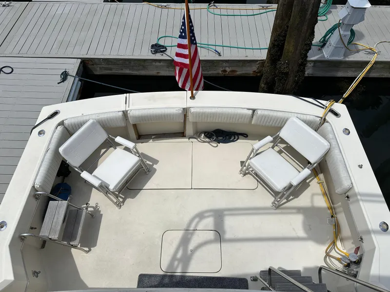 Slide: The Image of 1985 Hatteras 36 Convertible boat deck with seating and American flag. - 43
