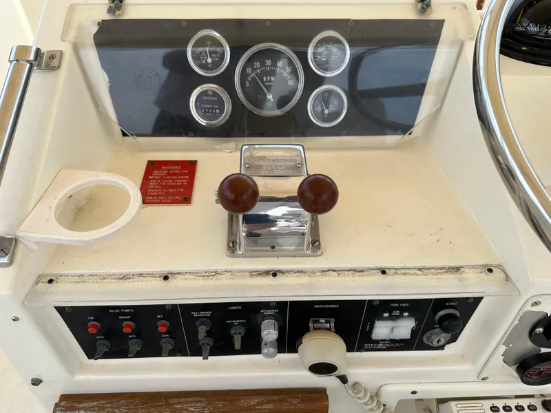 Slide: The Image of Control panel of a 1985 Hatteras 36 Convertible boat with gauges and switches. - 44