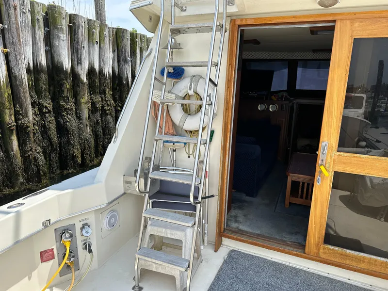 Slide: The Image of 1985 Hatteras 36 Convertible boat interior with ladder and wooden door. - 6