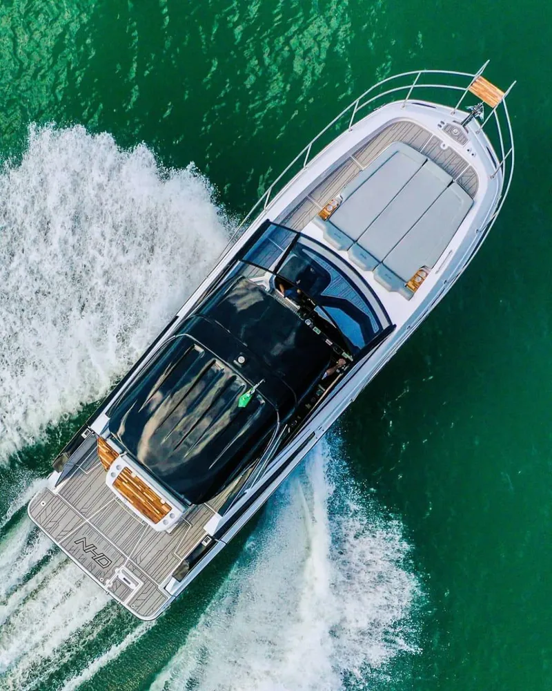 Slide: The Image of 2025 NHD 325 Open Deck boat cruising on green water. - 3