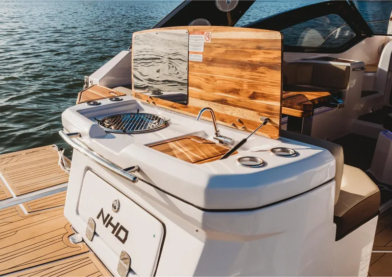 Slide: The Image of 2025 NHD 325 Open Deck boat with outdoor kitchen and sink. - 4