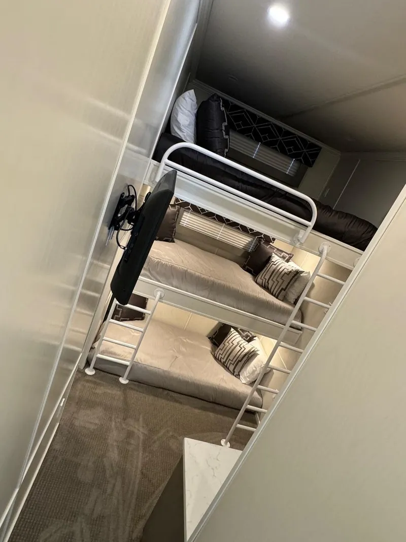 Slide: The Image of 2024 Sumerset Limitless Share 10 interior with bunk beds and modern decor. - 10