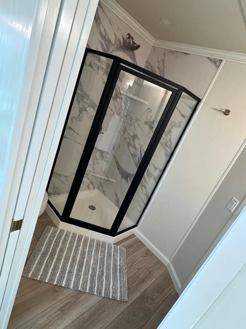 Slide: The Image of Modern bathroom in 2024 Sumerset Limitless Share 10 with glass shower enclosure. - 13