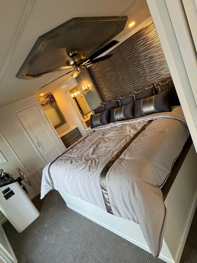 Slide: The Image of Luxurious bedroom in 2024 Sumerset Limitless Share 10 houseboat with modern decor and ceiling fan. - 19