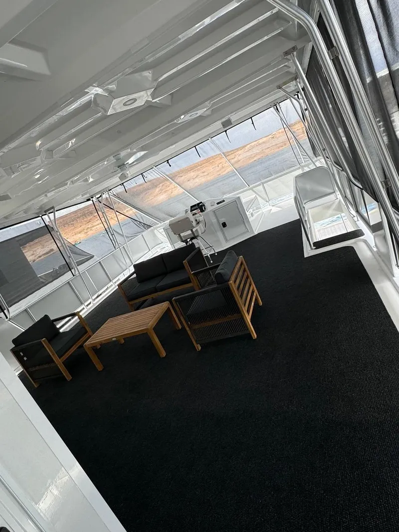 Slide: The Image of Spacious upper deck of 2024 Sumerset Limitless Share 10 houseboat with modern seating area. - 21