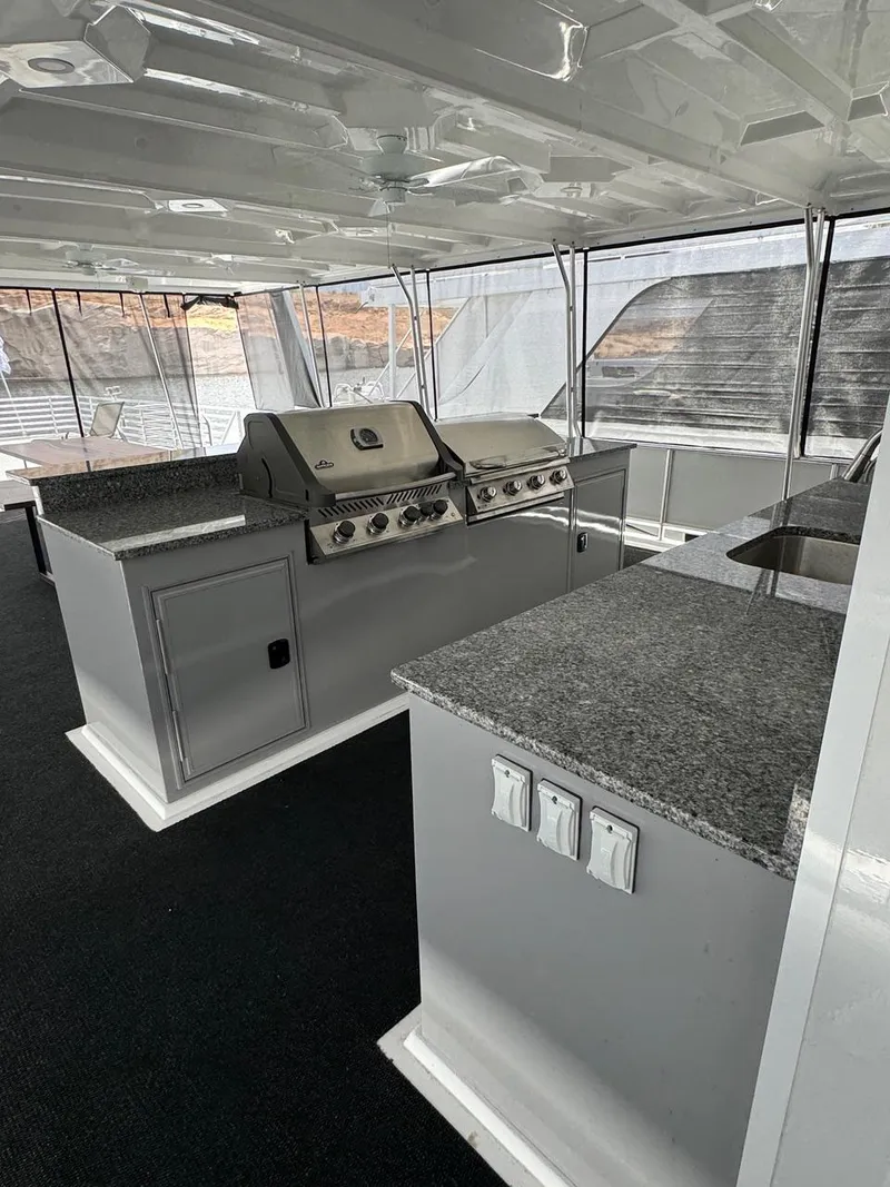 Slide: The Image of 2024 Sumerset Limitless Share 10 houseboat with modern outdoor kitchen and granite countertops. - 22